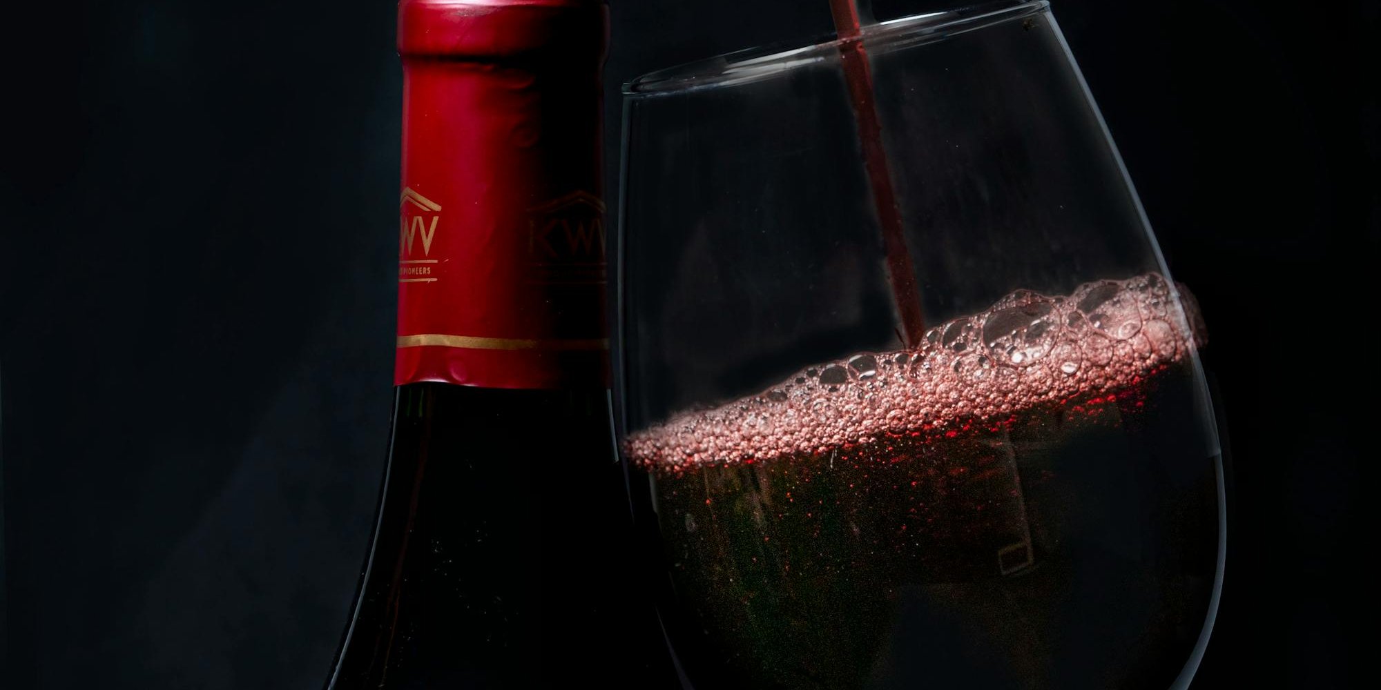 Bottles of aged Brunello di Montalcino wine displayed in a traditional Italian wine cellar